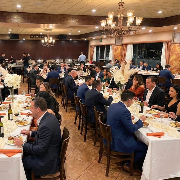 Diners enjoying a meal at long tables in a spacious Anejo Cantina and Grill dining room.